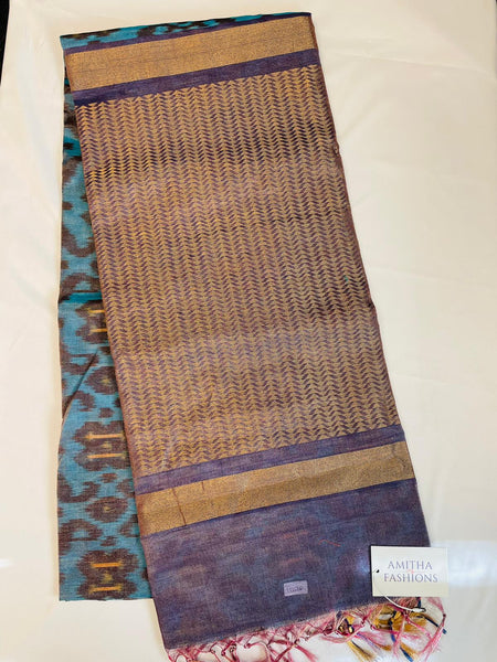 Pure Handloom Silk Ikkat Tissue saree in Blue w/ Browk Ikkat Weave. Has Dark Blue Tissue Border and Light Purple Zari Color Pallu. Comes w/ Light Purple Zari Blouse