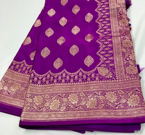 BKS115 Banarasi Mashru silk Saree in purple. Comes with gold zari work. Comes with stitched blouse size 38 can be altered to size 42. Fall peco done.