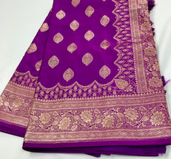 BKS115 Banarasi Mashru silk Saree in purple. Comes with gold zari work. Comes with stitched blouse size 38 can be altered to size 42. Fall peco done.