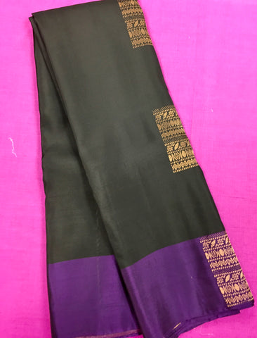 KSS438 kanchipuram silk Saree in black with purple gold zari border.comes with stitched blouse size 40,can be altered to 44 size.