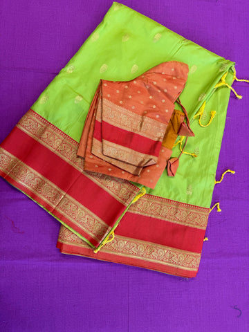 Semi kanjivaram soft silk Saree in Green with Orange border.Fall peco done. Comess with stitched blouse size 38 can be altered up to 44 size.