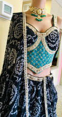AFL9006 Bandhani printed lehenga in black. Comes with  stitched blouse and dupatta.