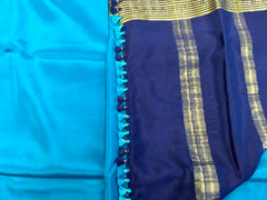 AMS1004 Pure Mysore Crepe silk Saree in blue color with dark blue gold zair border. Comes with unstitched blouse.