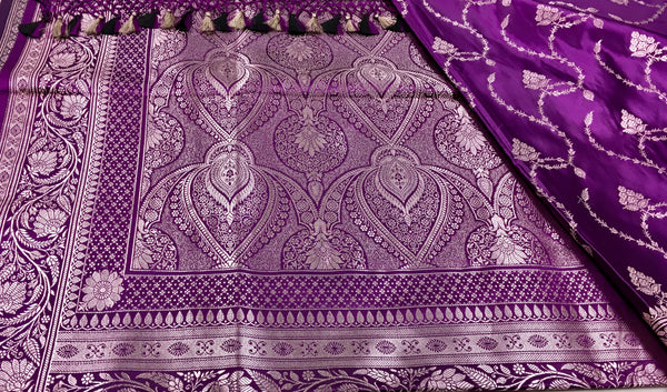 BKS130 Banarasi Mashru silk Saree in purple. Comes gold zari work. Comes with stitched blouse size 38 can be altered to size 42. Fall peco done.