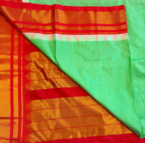 Korvai silk cotton saree in Green with orange border.Fall peco done. Comes with stitched blouse size 38 can be altered up to 44 size.