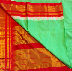 Korvai silk cotton saree in Green with orange border.Fall peco done. Comes with stitched blouse size 38 can be altered up to 44 size.