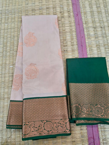 KSS342 Kanjivaram Semi Silk Saree In Beige w/ Bottle Green Border. Fall Peco done. Comes w/ stitched blouse size: 38 to 46.