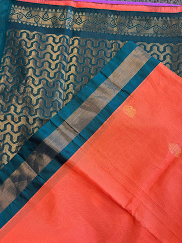 Korvai silk cotton saree in orange with Green gold zari  border.Fall peco done. Comes with stitched blouse size 38 can be altered up to 44 size.