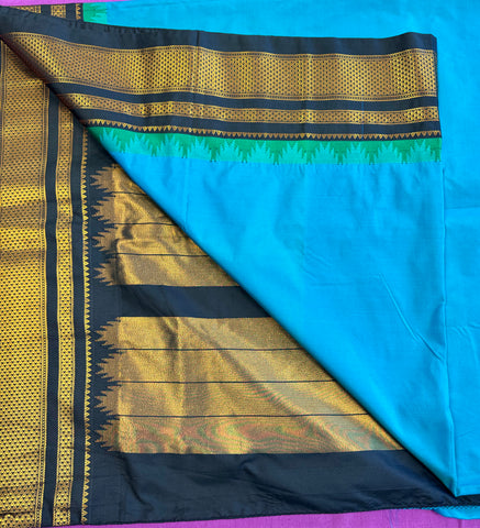 Korvai silk cotton saree in Blue with black border. Fall peco done. Comes with stitched blouse size 38 can be altered up to 44 size.