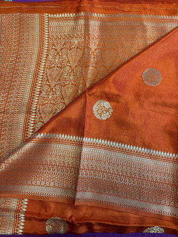 Maseru Silk Saree in Orange with Gold Zari border.Fall peco done. Comess with stitched blouse size 38 can be altered up to 44