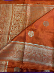 Maseru Silk Saree in Orange with Gold Zari border.Fall peco done. Comess with stitched blouse size 38 can be altered up to 44