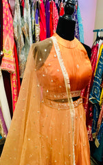 AFL9033 lehenga in orange . Comes with matching stitched blouse and dupatta.