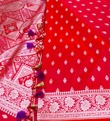 BKS116 Banarasi Mashru silk Saree in red.Comes with gold zari work. Comes with stitched blouse size 38 can be altered to size 42. Fall peco done.