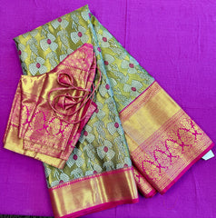Semi Silk Saree in green with pink Gold zari border. Comes with stitched blouse size 38 can be altered up to 44