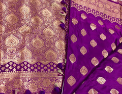 BKS115 Banarasi Mashru silk Saree in purple. Comes with gold zari work. Comes with stitched blouse size 38 can be altered to size 42. Fall peco done.