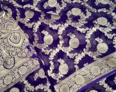 BKS112 Banarasi Georgette saree in purple. Comes with stitched blouse size 38 can be altered to size 42. Fall peco done.