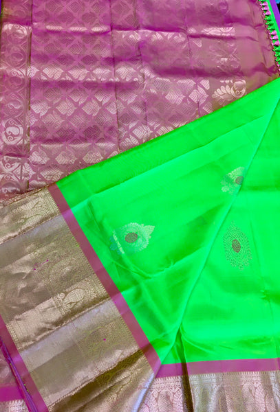 Pure kanchipuram Handloom Silk Saree in Parrot Green with Light Pink Zari border. Comes with Stitched Blouse size 38 can be altered up to 44
