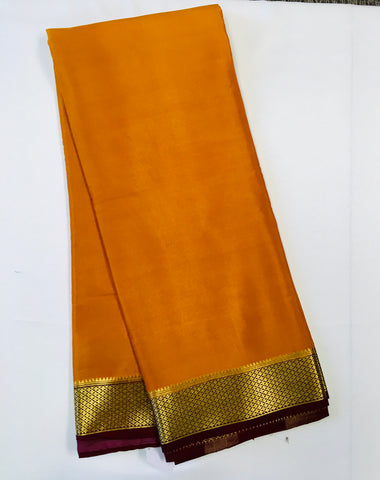 AMS1015 Pure Mysore Crepe silk Saree in mustard yellow color with brown gold zari border. Comes with unstitched blouse.