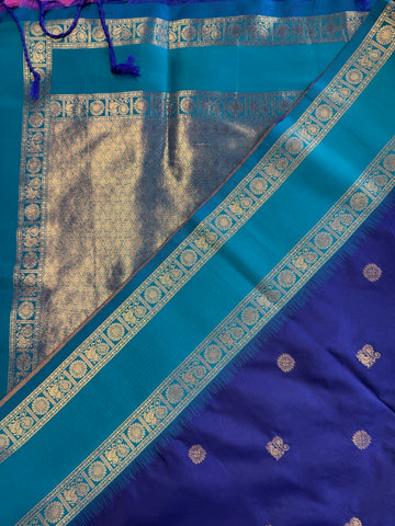 Semi kanjivaram soft silk Saree in Dark blue with light blue border.Fall peco done. Comess with stitched blouse size 38 can be altered up to 44 size.
