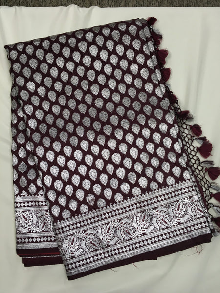 BKS125 Banarasi Mashru silk Saree in brown. Comes with silver zari work. Comes with stitched blouse size 38 can be altered to size 42. Fall peco done.