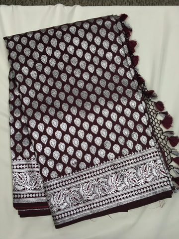 BKS125 Banarasi Mashru silk Saree in brown. Comes with silver zari work. Comes with stitched blouse size 38 can be altered to size 42. Fall peco done.