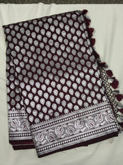 BKS125 Banarasi Mashru silk Saree in brown. Comes with silver zari work. Comes with stitched blouse size 38 can be altered to size 42. Fall peco done.