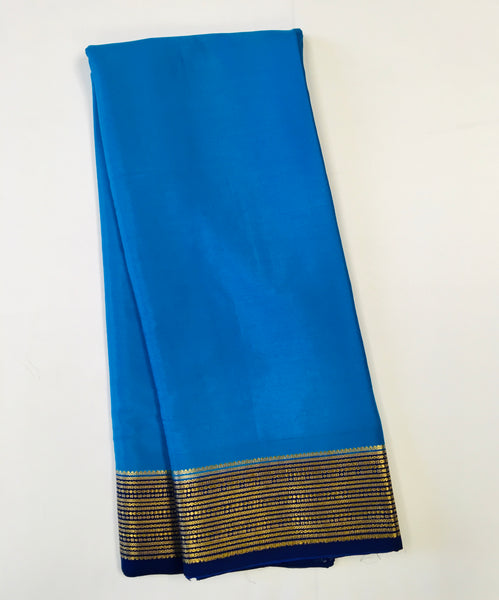 AMS1004 Pure Mysore Crepe silk Saree in blue color with dark blue gold zair border. Comes with unstitched blouse.