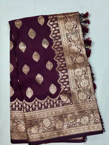 BKS127 Banarasi Mashru silk Saree in brown. Comes with gold zari work. Comes with stitched blouse size 38 can be altered to size 42. Fall peco done.