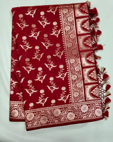 BKS121 Banarasi Mashru silk Saree in maroon. comes with gold zari work. Comes with stitched blouse size 38 can be altered to size 42. Fall peco done.