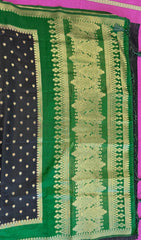 Banarasi Munga silk  saree in black  with Green border.Fall peco done. Comess with stitched blouse size 38 can be altered up to 44 size.