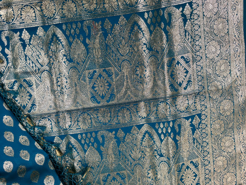 BKS124 Banarasi Mashru silk Saree in blue. Comes silver zari work. Comes with stitched blouse size 38 can be altered to size 42. Fall peco done.