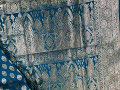 BKS124 Banarasi Mashru silk Saree in blue. Comes silver zari work. Comes with stitched blouse size 38 can be altered to size 42. Fall peco done.