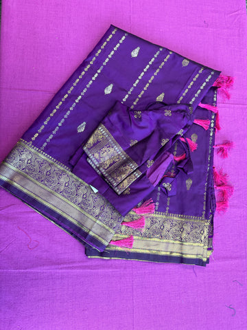 Banarasi silk  saree in purple  with Gold Zari border.Fall peco done. Comess with stitched blouse size 38 can be altered up to 44 size.