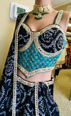 AFL9006 Bandhani printed lehenga in black. Comes with  stitched blouse and dupatta.