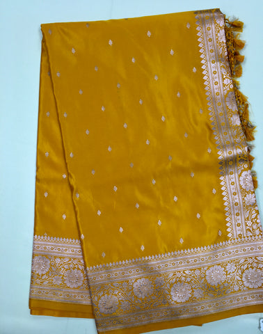 BKS117 Banarasi Mashru silk Saree in yellow. Comes with gold zari work. Comes with stitched blouse size 38 can be altered to size 42. Fall peco done.