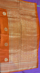 Maseru Silk Saree in Orange with Gold Zari border. Fall peco done. Comes with stitched blouse size 38 can be altered up to 44