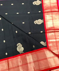 KSS428 Pure handloom kanchipuram silk Saree in black with red gold zari border.comes with stitched blouse size 40,can be altered to 44 size.