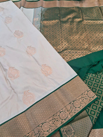 KSS342 Kanjivaram Semi Silk Saree In Beige w/ Bottle Green Border. Fall Peco done. Comes w/ stitched blouse size: 38 to 46.