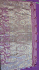 Banarasi Tussari georgette saree in Onion Pink with gold and silver zari border. Fall peco done. Comes with stitched blouse size 38 can be altered up to 44 size.
