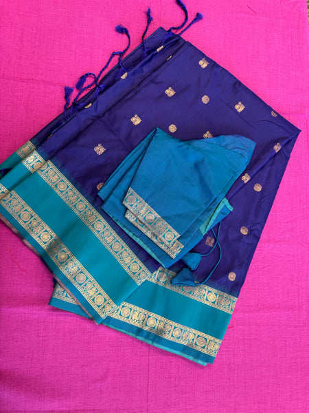 Semi kanjivaram soft silk Saree in Dark blue with light blue border.Fall peco done. Comess with stitched blouse size 38 can be altered up to 44 size.