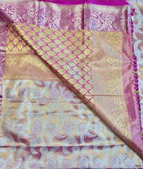 Semi silk Saree in Gold with Pink Border. Comess with stitched blouse size 38 can be altered up to 44