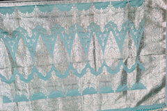 BKS118 Banarasi Mashru silk Saree in light blue. Comes with silver zari work. Comes with stitched blouse size 38 can be altered to size 42. Fall peco done.