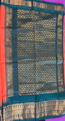 Korvai silk cotton saree in orange with Green gold zari  border.Fall peco done. Comes with stitched blouse size 38 can be altered up to 44 size.