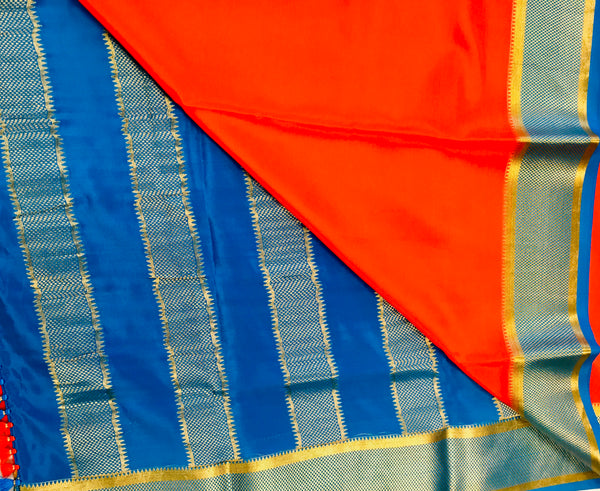 AMS1003 Pure Mysore Crepe silk Saree in orange color with blue gold zari border. Comes with unstitched blouse.