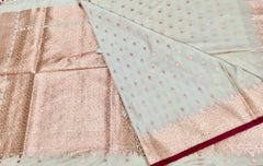 BKS131 Banarasi Mashru silk Saree in white.Comes with gold zari work. Comes with stitched blouse size 38 can be altered to size 42. Fall peco done.