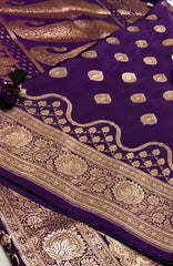 BKS129 Banarasi Mashru silk Saree in purple. Comes with gold zari work. Comes with stitched blouse size 38 can be altered to size 42. Fall peco done.