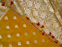 BKS119 Banarasi Mashru silk Saree in yellow. Comes with gold zari work. Comes with stitched blouse size 38 can be altered to size 42. Fall peco done.