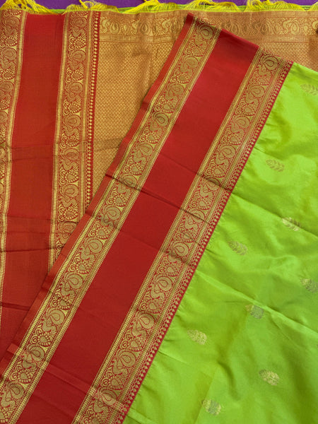 Semi kanjivaram soft silk Saree in Green with Orange border.Fall peco done. Comess with stitched blouse size 38 can be altered up to 44 size.