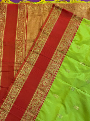Semi kanjivaram soft silk Saree in Green with Orange border.Fall peco done. Comess with stitched blouse size 38 can be altered up to 44 size.