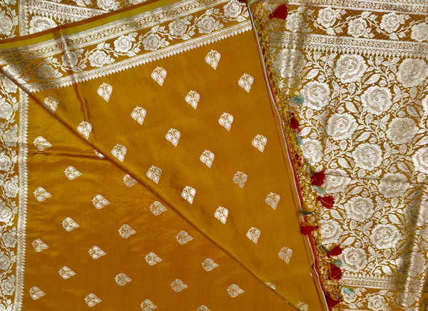 BKS119 Banarasi Mashru silk Saree in yellow. Comes with gold zari work. Comes with stitched blouse size 38 can be altered to size 42. Fall peco done.